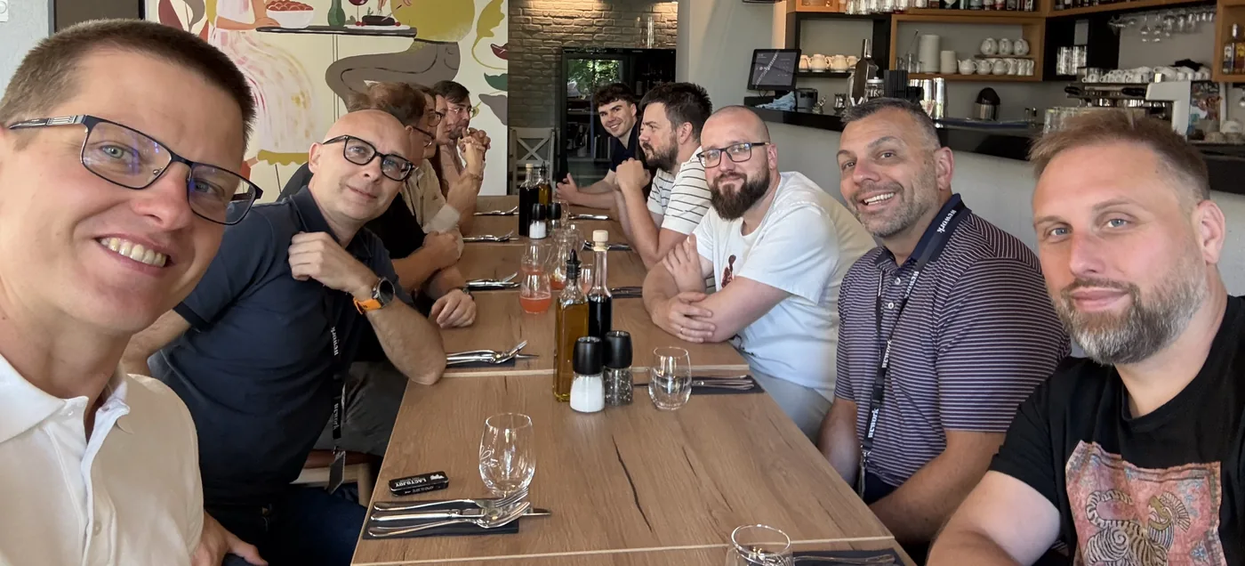 The WealthArc team around a long table over lunch